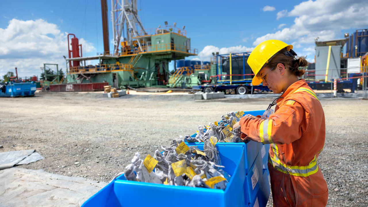 CUBO mud logger, Juliette Torres (CALS '23) takes samples of rock chips from the drill site for geological evaluation. (July 7, 2022)