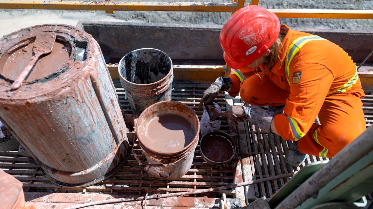 CUBO mud logger, Madeline Fresonke (ENG '23) takes samples of rock chips from the drilling mud at the drill site. (July 7, 2022)